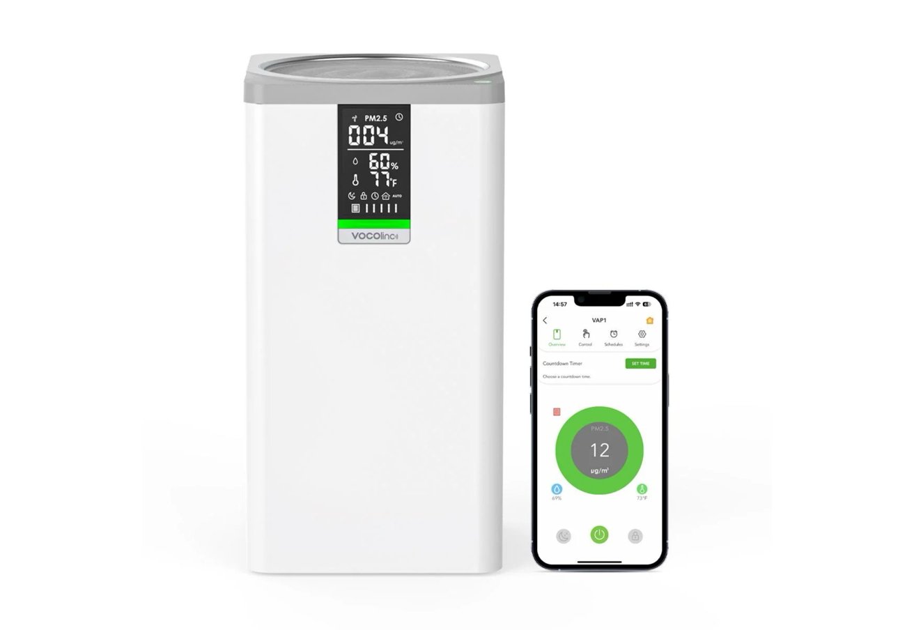 White air purifier with digital display showing air quality and a smartphone app interface displaying air monitoring data.